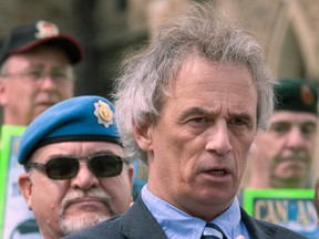 Former Veterans Ombudsman and Retired Col. Pat Stogran is surrounded by veterans as he speaks during a rally on Parliament Hill in Ottawa, Wednesday June 6, 2012. (THE CANADIAN PRESS/Adrian Wyld)