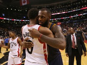 DeMar DeRozan (left) gets a hug from LeBron James as the Raptors lose to the Cavaliers in NBA action in Toronto on Oct. 28, 2016. (Stan Behal/Toronto Sun)