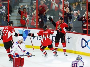 Senators defenceman Marc Methot (right) celebrates his goal with Jean-Gabriel Pageau (44) and Ben Harpur (67) as Rangers left wing Rick Nash (61) looks on during the second period in Game 2 of their NHL playoff series in Ottawa on Saturday, April 29, 2017. (Fred Chartrand/The Canadian Press)