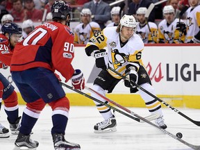 Pittsburgh Penguins left wing Carl Hagelin, of Sweden, chases the puck against Washington Capitals centre Marcus Johansson, also of Sweden, and centre  Lars Eller, of Denmark, during the first period of Game 2 in an NHL hockey Stanley Cup second-round playoff series, Saturday, April 29, 2017, in Washington. (AP Photo/Nick Wass)