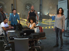 This image released by Universal Pictures shows, Chris "Ludacris" Bridges, seated left, and Nathalie Emmanuel, seated right, and Tyrese Gibson, standing from left, Scott Eastwood, Dwayne Johnson and Michelle Rodriguez in "The Fate of the Furious." (Matt Kennedy/Universal Pictures via AP)