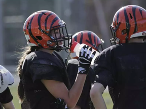 Laurie-Ange Clément takes a water break during spring training at Hormisdas-Gamelin High School in Buckingham, QC, on April 27, 2017. The football team is now inviting girls to play full contact football with the boys. (David Kawai) DAVID KAWAI / POSTMEDIA