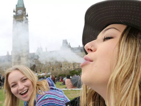 Two women smoke marijuana on Parliament Hill during 4/20 in Ottawa.