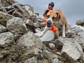 Buddy, 3, with his handler Jaimie Jackson of the Canadian Search and Rescue Dog Association held training sessions for dogs they send abroad to conduct rescues after natural disasters, on a big pile of rubble at a recycling depot in Sherwood Park, April 30, 2017. Ed Kaiser/Postmedia