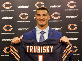 Chicago's first round draft pick quarterback Mitchell Trubisky poses with a Bears jersey during a news conference in Lake Forest , Ill., on Friday, April 28, 2017. (AP Photo/Charles Rex Arbogast)