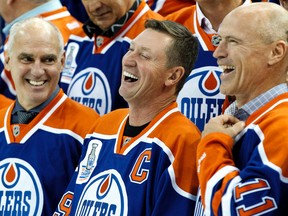 Lee Fogolin, left, Wayne Gretzky and Mark Messier share a laugh during an Edmonton Oilers media availability with the members of the Stanley Cup winning 1983-84 squad at Rexall Place in Edmonton on Oct. 8, 2014. Players and coaches spoke about the historic win against the New York Islanders, reminisced about the past and had a group photo taken. (Ian Kucerak)