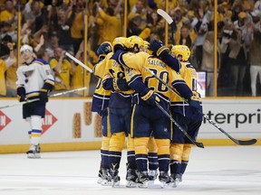 Predators players congratulate defenceman Roman Josi (59) after he scored a goal against the Blues during the third period in Game 3 of a second-round NHL playoff series in Nashville on Sunday, April 30, 2017. (Mark Humphrey/AP Photo)