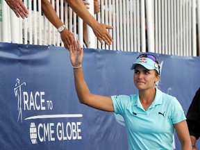 In this April 2, 2017, file photo, Lexi Thompson high fives fans as she walks to the 18th green in tears during the final round of the LPGA Tour ANA Inspiration tournament at Mission Hills Country Club in Rancho Mirage, Calif. The rules have changed on how video evidence can be applied, but it might not have changed what happened to Thompson. (AP Photo)