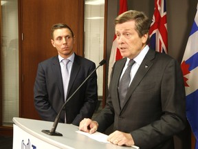 Ontario PC Leader Patrick Brown listens as Toronto Mayor John Tory addresses media at City Hall in Toronto, Ont. on Monday, May 1, 2017. (Michael Peake/Toronto Sun)