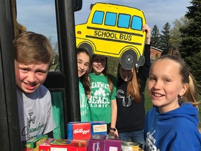 In St. Columban, students Sam Snyders (left), Jenna Deck, Samantha McCarthy, Danielle Vogels and Kirsten Kipfer load up a box of donated non-perishable food for eventual drop off to one of two St. Vincent de Paul Society locations, in Stratford and Goderich.  SUBMITTED