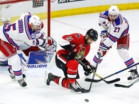 Ottawa Senators left winger Clarke MacArthur battles for the puck with New York Rangers defencemen Dan Girardi and Ryan McDonagh during Game 2 in Ottawa on April 29, 2017. (THE CANADIAN PRESS/Fred Chartrand)