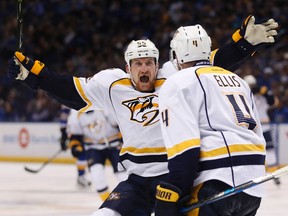 Nashville Predators left wing Cody McLeod (55) celebrates with defenseman Ryan Ellis (4) after Ellis scored against the St. Louis Blues during the third period in Game 2 of an NHL hockey second-round playoff series Friday, April 28, 2017, in St. Louis. AP Photo/Jeff Roberson