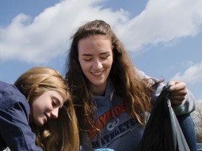 Morgan Basile and Jayna Mandin participate in Bayridge Secondary School’s Pitch-in event shortly after Earth Day. All the students went out into the school yard to pick up litter and collect it in bags to be sorted by their class. (Gracie Postma/For The Whig-Standard)