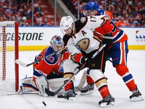 Anaheim Ducks' Ryan Kesler, centre, tries to get the puck past Edmonton Oilers goalie Cam Talbot, left, as Connor McDavid checks him during third period NHL hockey round two playoff action in Edmonton, Sunday, April 30, 2017.