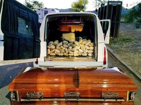 This Saturday, April 29, 2017 photo provided by U.S. Customs and Border Protection shows a hearse, the casket and the bricks of marijuana it was carrying after agents stopped the vehicle at an immigration checkpoint on State Route 80 near Tombstone, Ariz. The 67 pounds (30 kilograms) of marijuana were found inside the coffin Border Patrol officials said Monday, May 1, 2017. Drug-smelling dogs alerted agents. (U.S. Customs and Border Protection via AP)