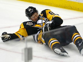 Pittsburgh Penguins' Sidney Crosby lies on the ice after taking a hit from Washington Capitals' Matt Niskanen during Game 3 in Pittsburgh on May 1, 2017. (AP Photo/Gene J. Puskar)