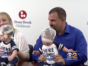 Michael and Amy Howard with two of their three triplets. (CBS New York)