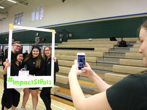Grade 12 student Danielle Green snaps a photo of fellow students at St. Patrick's Catholic High School Monday. More than 1,300 St. Pat's students participated in Sarnia's first-ever Impact Day, an event geared to raising awareness about risk-taking behaviours like distracted driving. Pictured in the frame are students Grace Beach, Sam McKibbin, Abigail Rogers and Hannah Fader. (Barbara Simpson/Sarnia Observer)