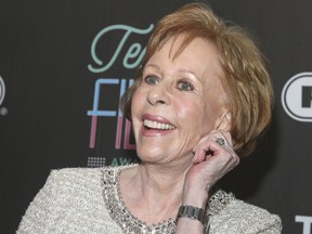 In this March 10, 2016 file photo, Texas Film Hall of Fame honoree Carol Burnett tugs on her ear at the 2016 Texas Film Awards at Austin Studios in Austin, Texas. The 84-year-old comedy legend could return to a full-time work schedule if the pilot she recently shot for ABC, "Household Name,” produced by Amy Poehler, becomes a regular series. (Photo by Jack Plunkett/Invision/AP, File)