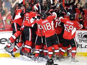 The Ottawa Senators celebrate a game-winning goal by Jean-Gabriel Pageau (obscured) during the second overtime period in game two of a second-round NHL hockey Stanley Cup playoff series against New York Rangers in Ottawa on Saturday, April 29, 2017. THE CANADIAN PRESS/Adrian Wyld