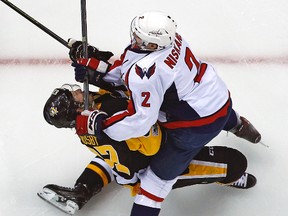 Penguins centre Sidney Crosby (87) takes a hit from Capitals defenceman Matt Niskanen during the first period of Game 3 of their NHL Eastern Conference semifinal series in Pittsburgh on Monday, May 1, 2017. Crosby left the game and did not return. (Gene J. Puskar/AP Photo)