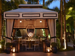This undated photo provided by The Monacelli Press shows an outdoor dining space at the Viceroy Santa Monica, in Santa Monica, Calif. The photo is featured in the book "Hotel Chic at Home" by Sara Bliss. Cabanas in the backyard, along with mirrors and lanterns, add elegance to a backyard for wedding celebrations, particularly for evening weddings and receptions. (The Monacelli Press via AP)