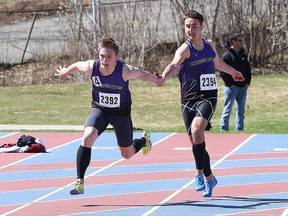 Lucas Mrozewski, left, and teammate Luca Nardi, of Lo-Ellen Knights, compete in the 4x100 relay event  at the LU Black Flies Track and Field Meet at the Laurentian University track in Sudbury on the weekend. John Lappa/Sudbury Star