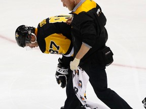 Pittsburgh Penguins' Sidney Crosby is helped off the ice after being injured during the first period of Game 3 in the NHL Stanley Cup Eastern Conference semifinals against the Washington Capitals on May 1, 2017. (AP Photo/Gene J. Puskar)