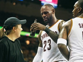 Cleveland Cavaliers forward LeBron James ends up with a beer bottle in his hand after running into a floor server while celebrating a victory against the Toronto Raptors during Game 1 on May 1, 2017 at Quicken Loans Arena. (Leah Klafczynski/Akron Beacon Journal via AP)