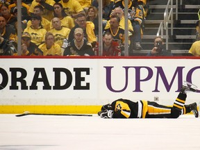 Sidney Crosby of the Pittsburgh Penguins lies on the ice after taking a hit in the first period while playing the Washington Capitals in Game 3 of the Eastern Conference semifinal during the NHL playoffs at PPG Paints Arena on May 1, 2017. (Gregory Shamus/Getty Images)