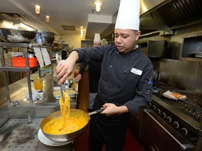 Executive chef Israel Sagulian creates Roasted Carrot and Ginger Pasta with Black Bean Patties in the kitchen at the Delta Armouries. (MORRIS LAMONT, The London Free Press)