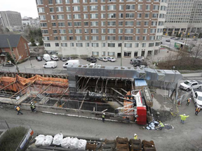 A crane flipped at the construction site of the east entrance of the LRT near Waller and Laurier after failing to lift a truck, in Ottawa on April 26, 2017.