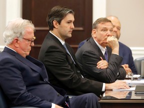 In this Monday, Dec. 5, 2016, file photo, defense attorneys Andy Savage, left, Don McCune, and Miller Shealy, right, sit around former North Charleston police officer Michael Slager at the Charleston County court in Charleston, S.C. (Grace Beahm/The Post And Courier via AP, Pool, File)