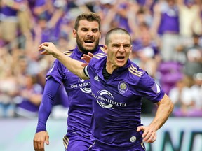 Orlando City’s Will Johnson (right) celebrates after scoring a goal against L.A. earlier this season. (AP)
