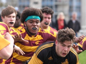 La Salle Black Knights’ Kody White runs with the ball as he’s pursued by Regiopolis-Notre Dame Panthers’ Jahmaal Branker during Kingston Area Secondary Schools Athletic Associaton senior boys rugby action at La Salle on Tuesday. Regi won the game, 17-12. (Ian MacAlpine/The Whig-Standard)