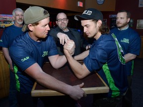 Team London arm wrestling team members Cam David, left, and Chase Zalepa tune up for the upcoming provincial championships to be held in London at Cowboys next week. Looking on are Paul Engel, Mark Zalepa and Mark Lacina. (MORRIS LAMONT, The London Free Press)