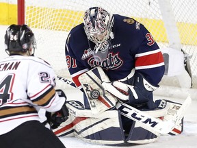 Calgary Hitmen Luke Coleman, left, tries to score on Regina Pats goalie Tyler Brown in WHL action at the Scotiabank Saddledome in Calgary, Alberta, on Wednesday, February 8, 2017. Leah Hennel/Postmedia