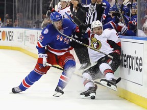 Brendan Smith of the New York Rangers checks Cody Ceci of the Ottawa Senators into the boards during Game 3 at Madison Square Garden on May 2, 2017. (Bruce Bennett/Getty Images)