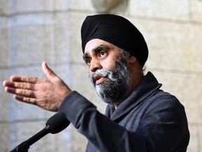 Minister of National Defence Harjit Sajjan speaks to reporters during a weekend meeting of the national caucus on Parliament Hill in Ottawa on Saturday, March 25, 2017. THE CANADIAN PRESS/Justin Tang