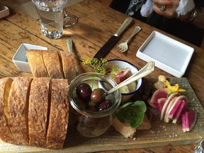 This Aug. 24, 2016 photo shows bread, olives and other pre-dinner nibbles served at The Lost Kitchen in Freedom, Maine, before the meal begins. The chef and owner Erin French got thousands of phone calls this year on April 1 when she opened reservations for the season for her 40-seat restaurant in an old mill in a tiny Maine town. French has just come out with a cookbook called "The Lost Kitchen: Recipes and A Good Life Found in Freedom, Maine," telling the remarkable story of her career from a teenager working in her dad's diner to giving dinner parties in her apartment to running a successful restaurant. (AP Photo/Beth J. Harpaz)