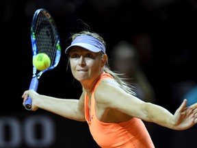 Russian tennis player Maria Sharapova returns the ball to Kristina Mladenovic from France during the Porsche Tennis Grand Prix in Stuttgart, Germany, Saturday, April 29, 2017. (Bernd Weissbrod/dpa via AP)