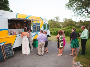 In this undated photo provided by Ava Marie Photography, Jay and Erin Gaskill, front of line, and their wedding guests order food from Boston-based food truck, Mei Mei, at their wedding in Sagamore Beach, Mass. (Katherine Harper/Ava Marie Photography via AP)