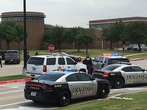 Officers work at a shooting scene on the North Lake College campus in Irving, Texas, Wednesday, May 3, 2017.  (Jae S. Lee/The Dallas Morning News via AP)