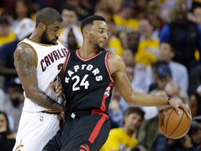 Toronto Raptors' Norman Powell is stopped by Cleveland Cavaliers' Kyrie Irving in the second half of Game 1 on May 1, 2017. (AP Photo/Tony Dejak)