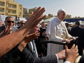 Pope Francis arrives at the Coptic Catholic College of Theology and Humanities in the southern Cairo suburb of Maadi, on April 29, 2017.
Pope Francis led a jubilant mass for thousands of Egyptian Catholics during a visit to support the country's embattled Christian minority and promote dialogue with Muslims. / AFP PHOTO / MOHAMED EL-SHAHEDMOHAMED EL-SHAHED