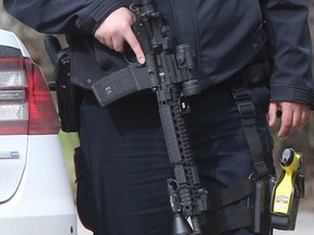 A police officer holds a rifle while working on an investigation in Winnipeg. Tuesday, April 26, 2017. 
Chris Procaylo/Winnipeg Sun