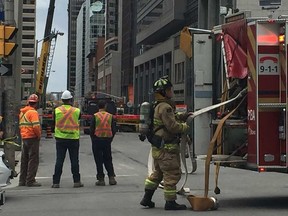 Emergency crews evacuated buildings and closed roads around a natural gas leak at a Queen Street construction site Tuesday afternoon. JON WILLING / POSTMEDIA