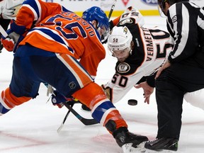 Edmonton Oilers centre Mark Letestu, left, takes a face-off against Anaheim Ducks centre Antoine Vermette at Rogers Place in Edmonton on April 30, 2017. (David Bloom)