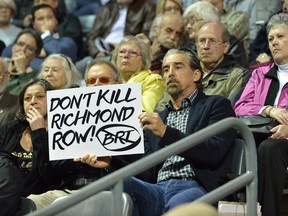 Londoners with signs at the public input meeting for the BRT at Budweiser Gardens on Wednesday. (MORRIS LAMONT, The London Free Press)