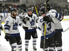 London Nationals Austin Kemp, Brendan Trottier, and Ethan Nother, celebrate with Quinn Lenihan, l-r, after he scored London's first goal against Elmira during a recent game of the Sutherland Cup final at the Western Fair Sports Centre. (MORRIS LAMONT, The London Free Press file photo)